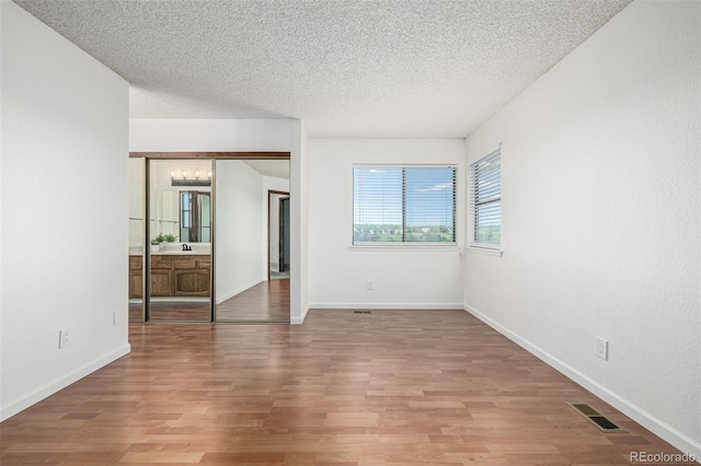 551 Snowy Owl Pl, Highlands Ranch, CO 80126 - unfurnished bedroom featuring a chandelier, a textured ceiling, and wood finished floors
