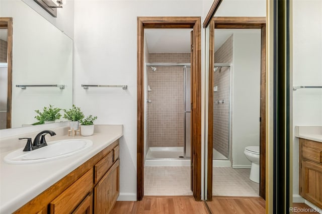 551 Snowy Owl Pl, Highlands Ranch, CO 80126 - bathroom with vanity, a shower stall, and wood finished floors
