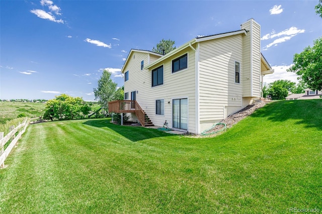 551 Snowy Owl Pl, Highlands Ranch, CO 80126 - back of house with stairway, a chimney, and a deck