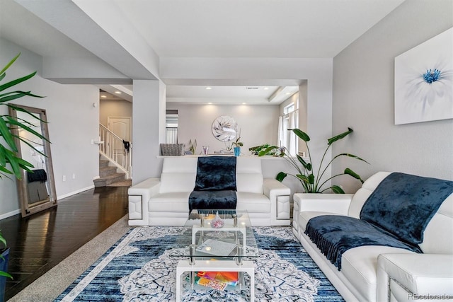 living room featuring recessed lighting, wood finished floors, baseboards, and stairs