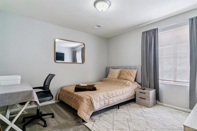 bedroom featuring light colored carpet, visible vents, and baseboards