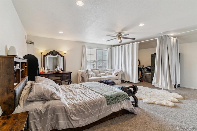 carpeted bedroom with a ceiling fan, recessed lighting, and a textured ceiling