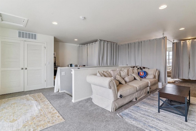 living area featuring recessed lighting, visible vents, and light colored carpet