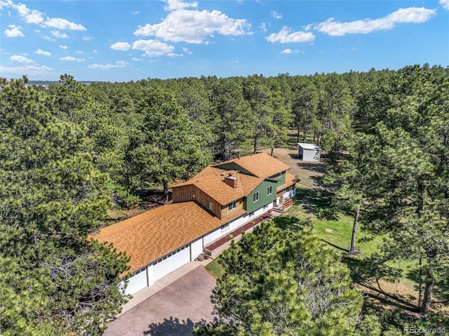 view of subject property with a heavily wooded area