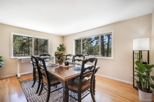 dining area featuring light wood-type flooring and baseboards