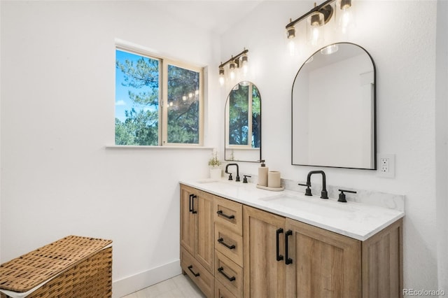 bathroom featuring double vanity and baseboards