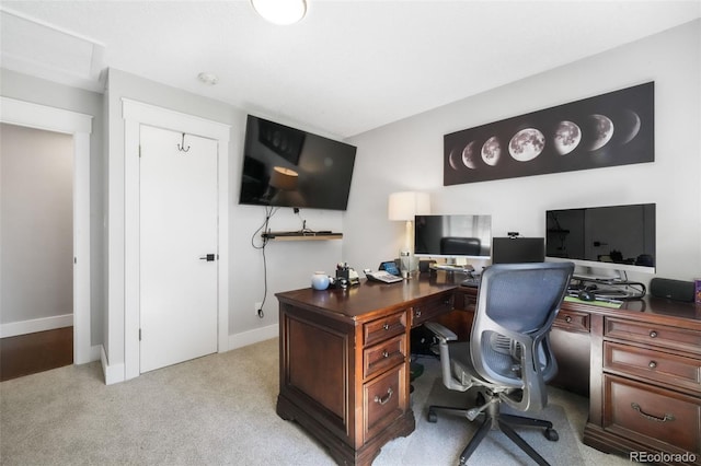 office area featuring light colored carpet and baseboards