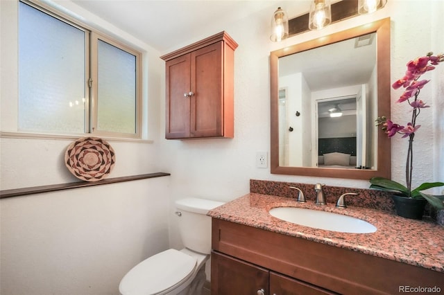 bathroom featuring toilet and vanity