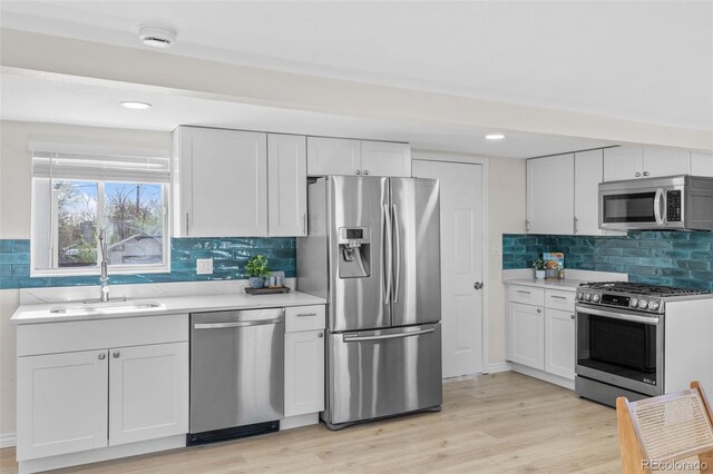 1130 Orchard St, Golden, CO 80401 - kitchen featuring stainless steel appliances, a sink, tasteful backsplash, white cabinetry, and recessed lighting
