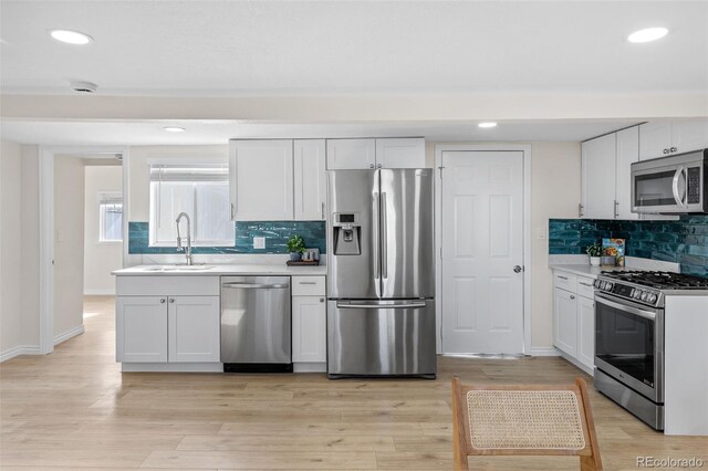 1130 Orchard St, Golden, CO 80401 - kitchen with stainless steel appliances, a sink, backsplash, light countertops, and recessed lighting