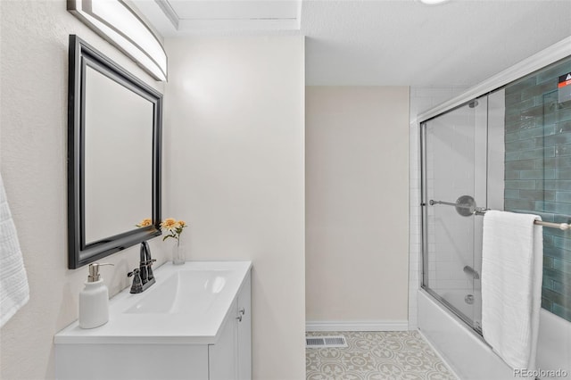 1130 Orchard St, Golden, CO 80401 - full bathroom with tile patterned flooring, enclosed tub / shower combo, vanity, and baseboards