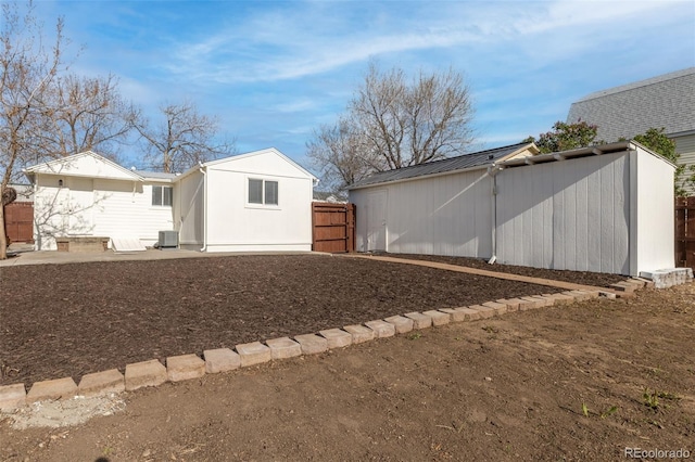 1130 Orchard St, Golden, CO 80401 - view of yard featuring central air condition unit, fence, and an outbuilding