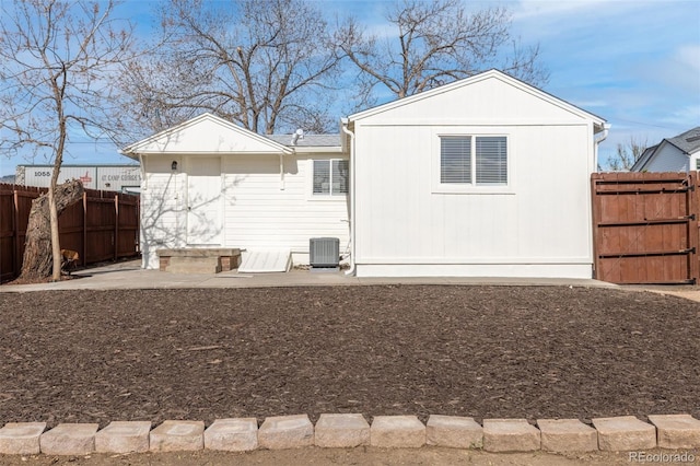 1130 Orchard St, Golden, CO 80401 - back of property featuring central air condition unit, a fenced backyard, and a gate
