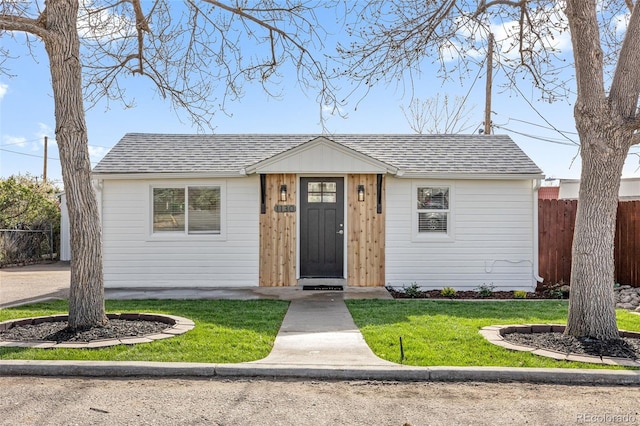 1130 Orchard St, Golden, CO 80401 - view of front of home with a front lawn, roof with shingles, and fence