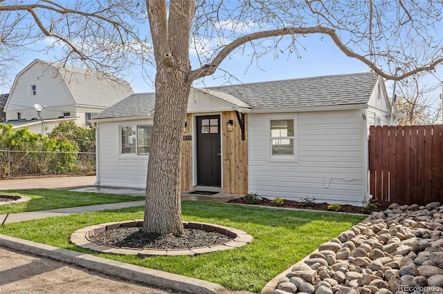 1130 Orchard St, Golden, CO 80401 - view of front of home with roof with shingles, fence, and a front lawn