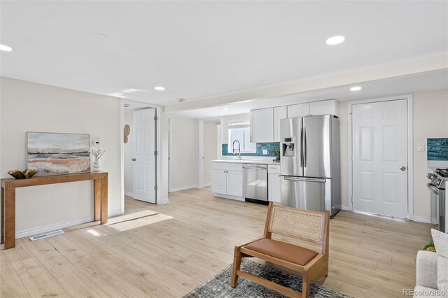 1130 Orchard St, Golden, CO 80401 - living area with light wood-style floors, visible vents, baseboards, and recessed lighting