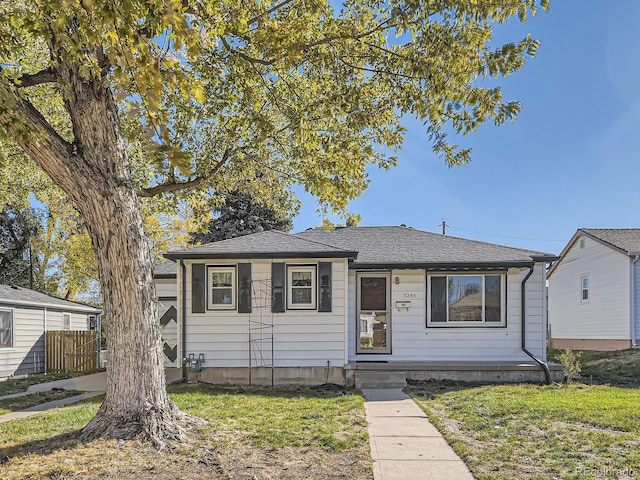 bungalow-style house featuring a front lawn