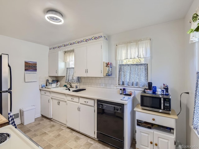 kitchen featuring white cabinetry, backsplash, and appliances with stainless steel finishes