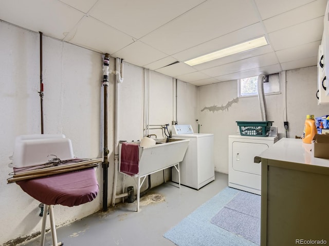 clothes washing area with sink and washing machine and dryer