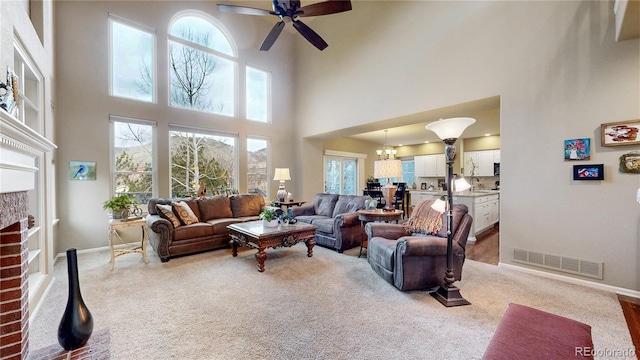 living room featuring baseboards, visible vents, and light carpet