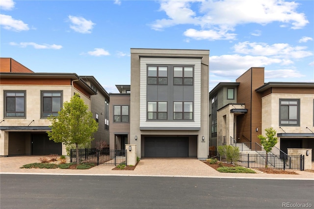 10113 Bellwether Ln, Lone Tree, CO 80124 - contemporary home with decorative driveway, a garage, fence, and stucco siding