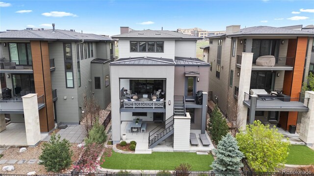 10113 Bellwether Ln, Lone Tree, CO 80124 - view of front of property with stairs, a patio area, metal roof, and a standing seam roof