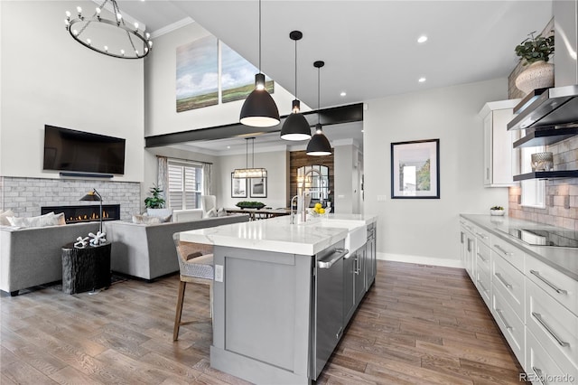 10113 Bellwether Ln, Lone Tree, CO 80124 - kitchen with crown molding, black electric cooktop, white cabinets, and a sink
