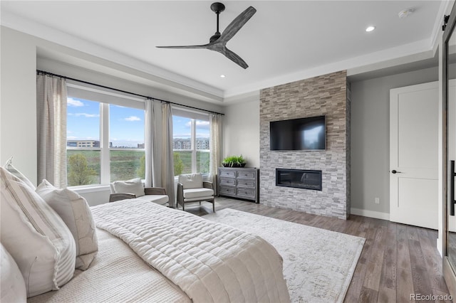 10113 Bellwether Ln, Lone Tree, CO 80124 - bedroom with a ceiling fan, a stone fireplace, wood finished floors, baseboards, and recessed lighting