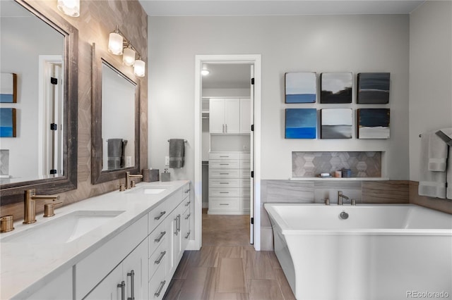 10113 Bellwether Ln, Lone Tree, CO 80124 - bathroom with double vanity, a freestanding bath, a sink, and tasteful backsplash
