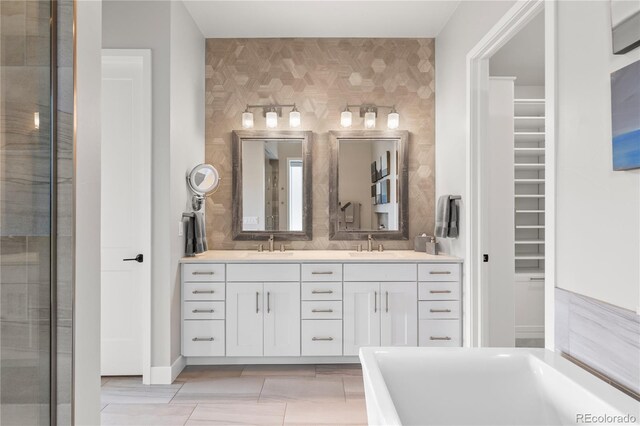 10113 Bellwether Ln, Lone Tree, CO 80124 - full bath featuring double vanity, a walk in closet, a shower with shower door, a sink, and a soaking tub