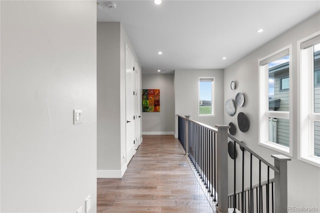 10113 Bellwether Ln, Lone Tree, CO 80124 - corridor featuring recessed lighting, baseboards, light wood-type flooring, and an upstairs landing