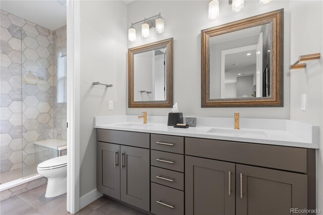 10113 Bellwether Ln, Lone Tree, CO 80124 - full bath with double vanity, a shower stall, toilet, and a sink