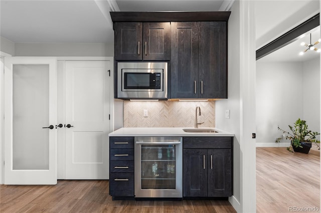 10113 Bellwether Ln, Lone Tree, CO 80124 - bar with a sink, wine cooler, wood finished floors, and stainless steel microwave