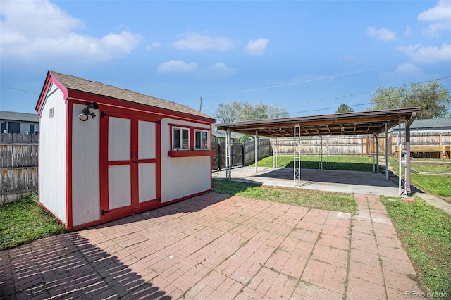 view of shed with a fenced backyard and a carport