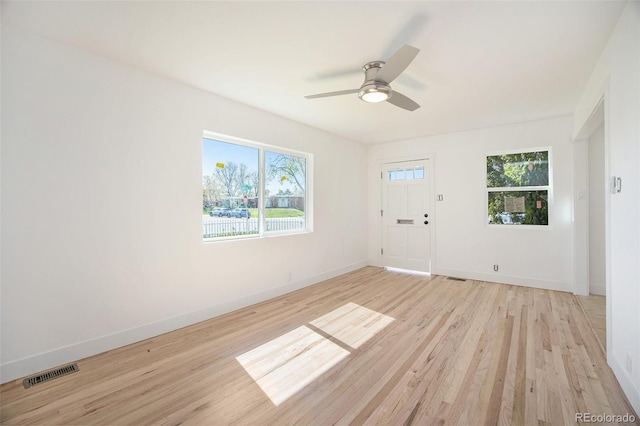 unfurnished room with light wood-type flooring, baseboards, and a ceiling fan