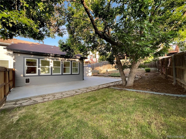 12375 Ivy Pl, Brighton, CO 80602 - fenced backyard with a patio area
