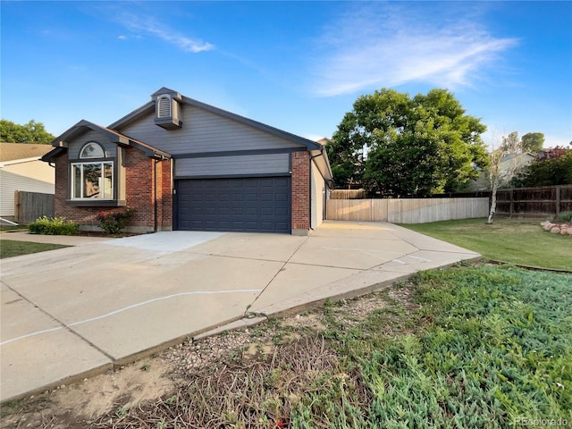 12375 Ivy Pl, Brighton, CO 80602 - view of front of house featuring driveway, a garage, and brick siding