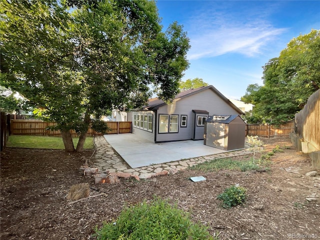 12375 Ivy Pl, Brighton, CO 80602 - rear view of house featuring a storage shed, a patio area, and a fenced backyard