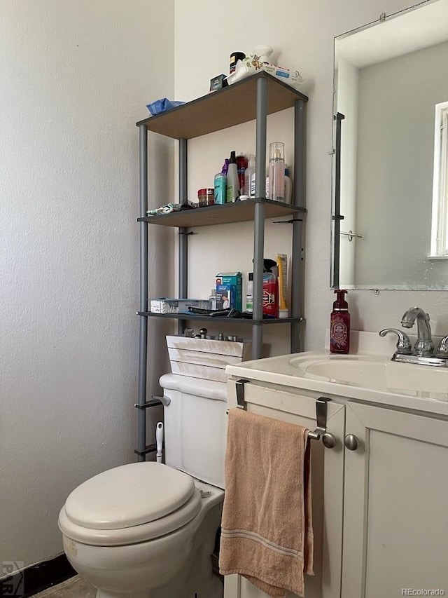 bathroom featuring vanity and toilet