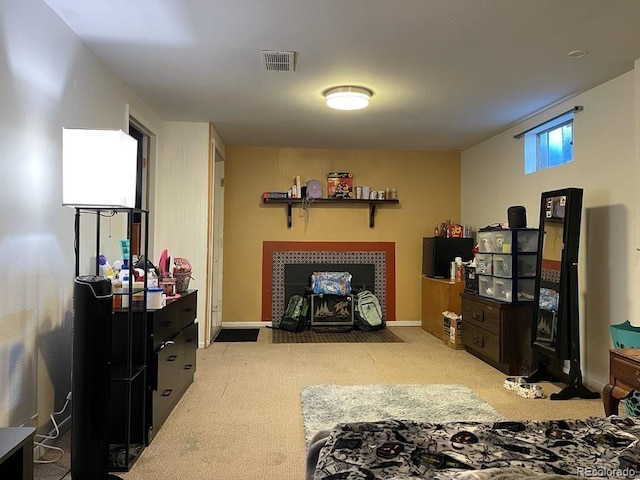 interior space with a tile fireplace and light carpet