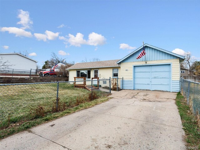 view of front of home featuring a fenced front yard, concrete driveway, a front lawn, and a garage