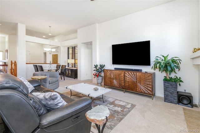 carpeted living room featuring a chandelier