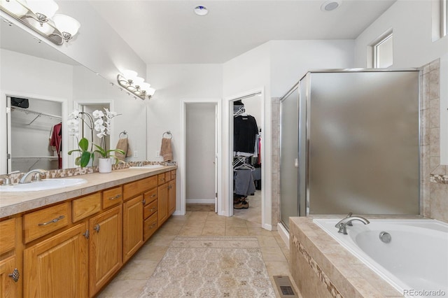 bathroom with tile patterned flooring, vanity, and shower with separate bathtub