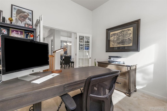 carpeted office with a chandelier