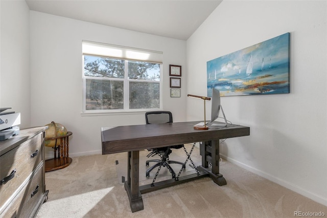 home office featuring light carpet and vaulted ceiling