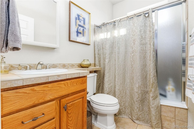 bathroom featuring walk in shower, tile patterned flooring, vanity, and toilet