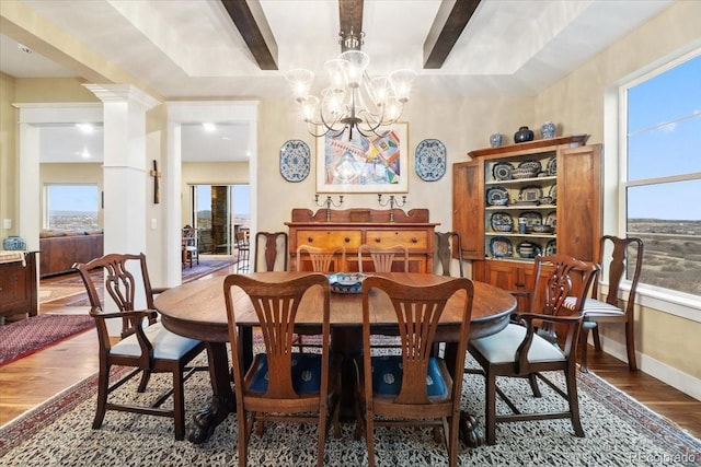 dining space featuring a chandelier, dark wood-style flooring, and baseboards