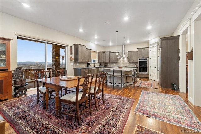 dining space featuring dark wood-style floors