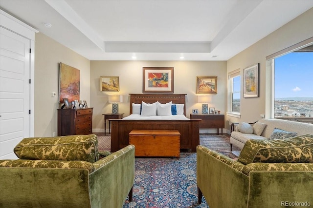 carpeted bedroom with baseboards, a tray ceiling, and recessed lighting
