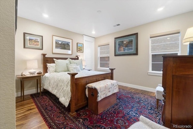 bedroom featuring recessed lighting, baseboards, visible vents, and wood finished floors